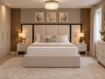 Extended wide headboard panel bed in cream fabric, front view in a hotel-style bedroom