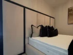 Extended panel headboard bed real customer photo showing headboard extending beyond the bed